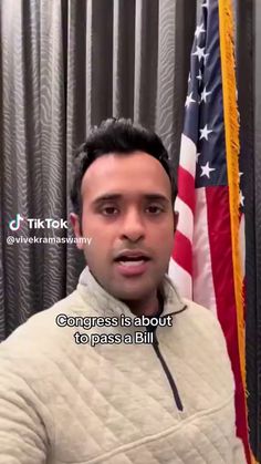 a man standing in front of an american flag