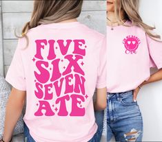 a woman wearing a pink shirt with the words five six seven ate printed on it