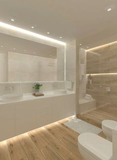 a modern bathroom with wooden flooring and white fixtures on the walls, along with two sinks