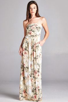 It's not your Grandma's 'antique roses' type of floral dress! This pretty ivory maxi dress features an antique china floral pattern of cream, blush and olive. The perfect romantic date night dress features a strapless neckline, empire waist and practical side pockets. Estimated 2-4 business days for shipping. Available in ivory/blush Made in the USA 96% polyester and 4% spandex Elegant White Dresses With Rose Detail, Spring Dress With Rose Detail And Fitted Bodice, Spring Dresses With Rose Detail And Fitted Bodice, Fitted White Dress With Rose Detail, Flowy Rose Print Dress For Garden Party, Chic Cream Maxi Dress With Fitted Bodice, Feminine Cream Dress For Garden Party, Cream Strapless Dress With Fitted Bodice, Strapless Cream Dress With Fitted Bodice