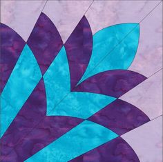 a purple and blue quilt with leaves on it