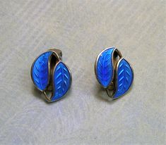 "Vintage Sterling Enamel David Andersen Modernistic Double Leaf Earrings, Sterling Norway Enamel Earrings Beautiful vintage sterling and blue enamel double leaf earrings signed by David Andersen of Norway. They were produced in the 1950's and are mid-century modern at its finest! The earrings are the double leaf pattern and have beautiful bright blue enamel. The earrings are clip-ons. Absolutely beautiful!! ♦ Material: Sterling silver with guilloche enamel ♦ Age: 1950's ♦ Maker's Mark: D-A 925S Guilloche Enamel, Rhinestone Shoes, Enamel Earrings, Shoe Clips, Maker's Mark, Leaf Earrings, Leaf Pattern, Bright Blue, Makers Mark