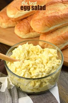 an egg salad in a glass bowl next to bread on a cutting board with text overlay that reads the best egg salad