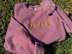 We're all about the cute, vintage look and comfortable wear. This embroidered sweatshirt is absolutely ideal for a day in or out! I embroidered this sweatshirt with a sunflower design🌻 Item Details * Color of the sweatshirt is Heathered Maroon. * Sizing is unisex. If you want an oversized look, size up. * I designed and embroidered this sweatshirt myself. This sweatshirt is unique and handmade. Material * 50/50 cotton/polyester blend. * Spun yarn for softer feel and reduced pilling. * Double-ne Spring Crew Sweatshirt With Embroidered Logo, Embroidered Long Sleeve Sweatshirt For Spring, Casual Sweater With Floral Embroidery, Trendy Sweatshirt With Custom Embroidery For Fall, Spring Floral Embroidered Crew Neck Sweatshirt, Spring Cotton Sweatshirt With Floral Embroidery, Floral Embroidery Cotton Sweatshirt For Spring, Cotton Floral Embroidery Sweatshirt For Spring, Spring Casual Sweatshirt With Embroidered Graphics