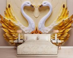 two white swans in the middle of a bed