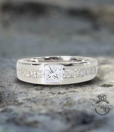 a white gold ring with princess cut diamonds