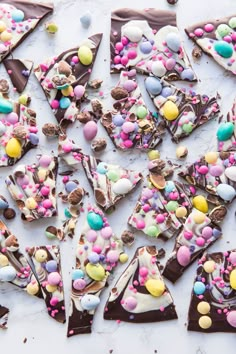 several pieces of chocolate with candy and candies on them, arranged in the shape of triangle