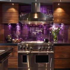 a stove top oven sitting inside of a kitchen next to a wall mounted range hood