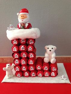 a santa clause is sitting on top of many rolls of toilet paper with teddy bears