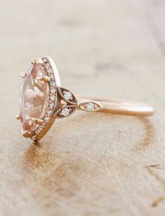 Rose - what a precious color. Our Rachael is 14k rose gold elegance and mystic wrapped into one. Set with an 12x6mm marquise shaped Morganite Approx Band Width (mm): 1.80mm Setting Diamond Quality (side stones): Colorless and VS clarity Approx Setting Total Carat Weight (side stones): 0.17 tcw Approx Production Time: 5-6 weeks Drop-down diamond options represent our recommended grade, which maximizes size for value, while maintaining eye-perfect clarity and giving you a colorless look. For other Marquise Pink Rings With Accent Stones, Marquise Rose Cut Diamond Rings In Pink, Luxury Marquise Cut Rose Gold Ring, Pink Marquise Rose Cut Diamond Rings, Marquise Cut Rose Diamond Rings, Morganite Engagement Ring Rose Gold, Rose Gold Morganite, Halo Engagement, Halo Engagement Ring