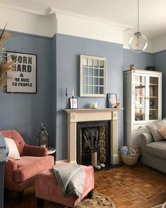 a living room filled with furniture and a fire place next to a wall mounted clock