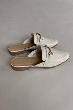 The Reese Slide Mules features a golden metallic buckle, ivory faux leather, and a slide-on style. We recommend sizing up half a size in this style. Slides Women, Slides, Faux Leather, Buckle, Boutique, Leather