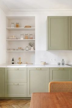 the kitchen is clean and ready for us to use it's green cabinetry