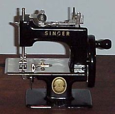 an old sewing machine sitting on top of a wooden table