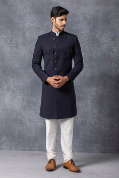 Navy blue pathani style sherwani with asymmetric button placket and flap pockets. Paired with kurta and churidar.
Components: 3
Fabric: Suiting
Neckline: Mandarin
Sleeve Length: Full
Color: Blue
Asymmetric button placket - Aza Fashions Blue Sherwani, Mens Sherwani, Dress Suits For Men, Bespoke Suit, Bespoke Tailoring, Suit Fabric, Churidar, Dress Suits, Mandarin Collar