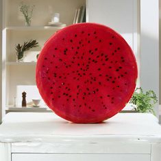 a watermelon slice sitting on top of a white cabinet