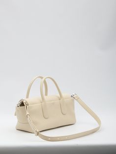 Tod's Di Bag Reverse EW Flap small in cream-colored calfskin with embossed Tod's logo on the front. It features fixed double handles, adjustable and detachable shoulder strap, magnetic flap, interior zip closure, one main interior compartment and one interior zip pocket. Dimensions: 36x16x13cm  Size nationality: UNI  Product number: 39736519  Product code: XBWDBRI0200YATB019  Composition: 100% calfskin Modern Beige Bags With Rolled Handles, Classic Beige Bags With Rolled Handles, Timeless Rectangular Bags With Rolled Handles, Timeless Cream Rectangular Satchel, Modern Cream Rectangular Satchel, Classic Rectangular Bag With Rolled Handles, Modern Cream Shoulder Bag With Detachable Handle, Modern Beige Satchel With Rolled Handles, Everyday Double Handle Bags With Rolled Handles