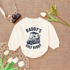 Daddy's Golf Buddy Golf Cart Father Golfing Boys T-Shirt Baby Romper ,Golfing Buddy , Cute Romper Sweatshirt , Baby Romper Announcement - Handmade  - Ships from USA  - Materials: 100% CPSIA Compliant and Ethically Made material Light fabric (5.0 oz/yd² (170 g/m  Crafted with soft, breathable fabric, this romper ensures your baby stays comfortable through playtimes and nap times alike. Featuring charming designs suitable for all babies, our romper is as adorable as it is practical.  Quick Sizing White Cartoon Print Tops For Sports, White Cartoon Print Sports Top, Nap Times, M Craft, Cute Rompers, Golf Cart, Gender Neutral Baby, Baby Romper, Boys T Shirts