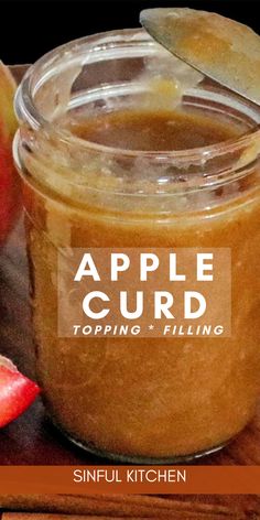 an apple curd topping in a glass jar next to sliced apples