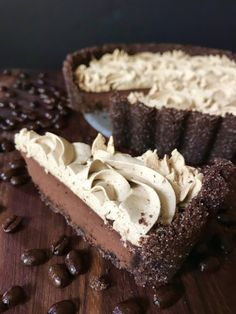 a piece of chocolate pie with whipped cream on top and coffee beans around it, ready to be eaten