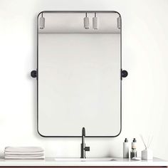 a bathroom sink with a mirror above it and soap dispensers on the counter