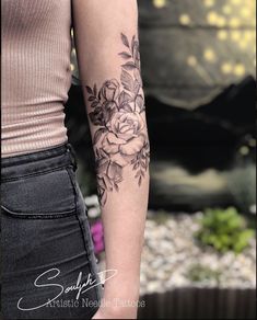 a woman with a flower tattoo on her arm