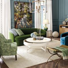 a living room with blue walls and green furniture in the center, along with white rugs