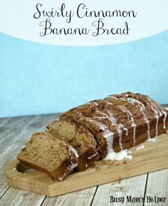 a loaf of cinnamon banana bread on a cutting board with icing drizzled