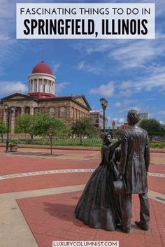 a statue of a man and woman in front of a building