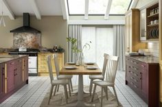 a kitchen with a table and chairs next to a stove top oven in the corner