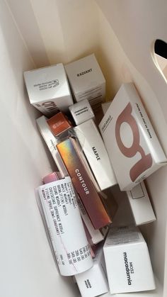 many different types of cosmetics are in a white container