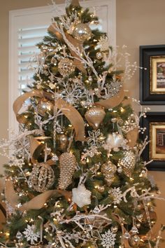 a christmas tree with gold and white ornaments on it is featured in the facebook page