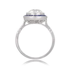 "Notable for it's size, this ring features a 4.49 carat natural Sapphire. Along the shoulders are two additional step-cut sapphires, followed by graduating baguette-cut diamonds. This ring is vintage, circa 1960. ✦ SAPPHIRE SPECIFICATIONS: Sapphire Cut: Cushion Cut Sapphire Weight 4.49 Carats ✦ ENGAGEMENT RING SPECIFICATIONS: Ring Material: Platinum Stones: Diamond, Sapphire ✦ WHAT COMES IN YOUR SHIPMENT: - Your Engagement Ring - Quality Ring Box - Jewelry Cleaner - UGL Certificate ✦ WHY SHOP WI Gia Certified Cushion Cut Sapphire Ring In Platinum, Gia Certified Emerald Cut Sapphire Ring In Platinum, Art Deco Oval Sapphire Ring With Prong Setting, Art Deco Gia Certified Round Cut Sapphire Ring, Timeless Gia Certified Platinum Sapphire Ring, Platinum Diamond Ring With Asscher Cut Gemstone, Asscher Cut Diamond Ring In Platinum, Formal Asscher-cut Lab-created Sapphire Ring, Asscher Cut Diamond Platinum Ring