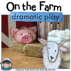 two paper farm animals sitting next to each other on a wooden table with the words on the farm dramatic play