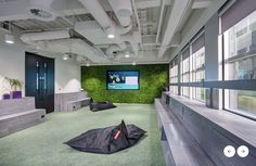 an office with green walls and black umbrellas on the floor in front of it