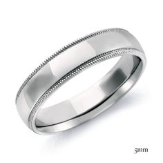 a white gold wedding ring with milnizing details on the outside and inside, set in 18k white gold