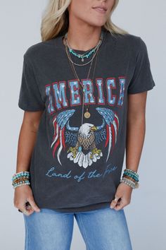 Get ready for your new favorite graphic tee, the Land Of The Free Graphic Tee is the perfect essential to your boho looks that will have you grabbing for it all year long! Comfortable, mineral - washed, Cotton tee shirt fabric Relaxed and loose tee shirt silhouette Classic crew neckline and loose short sleeves Perfect for Fourth of July Eagle with American flag 'America' graphic *Due to lighting and differences in monitors, actual colors may vary slightly from what appears online. Model is 5'8" Festival Washed Graphic Tee T-shirt, Festival Washed Graphic T-shirt, Festival Graphic Tee T-shirt Washed, Festival Graphic Tee With Washed Detail, Festival Soft-washed Crew Neck T-shirt, Stonewashed Graphic Tee For Spring, Festival Graphic Tee With Vintage Wash, Spring Stonewashed Graphic Tee, Free-spirited Cotton Crew Neck T-shirt