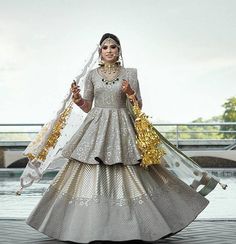 a woman in a white and gold wedding dress