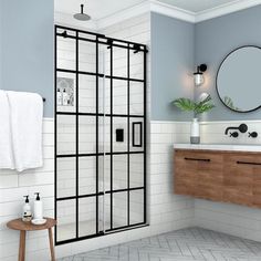 a bathroom with a sink, mirror and shower stall in the middle of the room