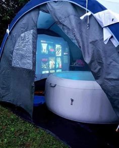 an inflatable tent with a hot tub and screen on the inside is set up outside