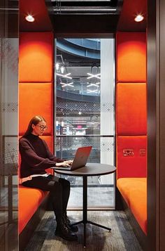 a woman sitting at a table with a laptop