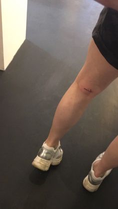 a woman's leg with a small tattoo on it