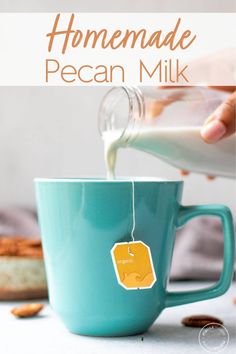 homemade pecan milk being poured into a blue mug with the words, homemade pecan milk