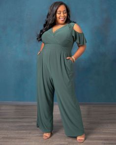 A "tastemaker" is defined as one whose influence defines what is fashionable.  We couldn't help but name this silhouette the Tastemaker as it's a perfect balance of easy fit and effortless style.  This one and done plus size jumpsuit creates an influencer status statement of what is fashionable and features details like pleating at the waist, cold shoulder sleeves with a fun flounce and zipper in back. Jumpsuit And Cardigan, Cold Shoulder Sleeves, One And Done, Chic Cardigan, Evening Gown Dresses, Plus Size Jumpsuit, Casual Wedding, Jumpsuit Fashion, Maxi Wrap Dress