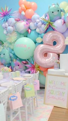 a table with balloons and decorations for a baby shower