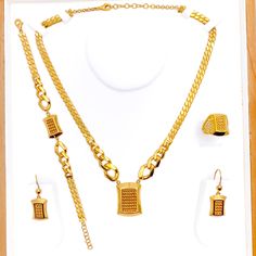 The Distinct Block Style 5-Piece Necklace Set, made from 21k yellow gold and weighing 49.0 grams, showcases modern elegance. The set includes an 18-inch necklace with a 1.1-inch drop, complemented by 1.5-inch adjustable links and a secure lobster lock. The ensemble features 1.6-inch earrings with hook backs, an 8.25-inch bracelet with 1-inch adjustable links, and a size 8 ring, all consistent with the distinct block design. This set is perfect for those who prefer bold, contemporary jewelry with the classic appeal of gold. PRODUCT DETAILS Gold Purity(karat): 21k Gold Weight(grams): 49.0 Item Finish: Yellow Gold Set Length: 18" Drop Length: 1.1" Adjustable Links: 1.5" Links Lock Style: Lobster Lock Matching Earrings: Included Earring Length: 1.6" Earring Post: Hook Back Matching Bracelet: I 22k Gold Dual-tone Necklace Gift, Festive 22k Gold Hand-set Necklaces, Gold-plated Yellow Gold Costume Jewelry Sets, Luxury 22k Gold Hand-set Necklace, Nickel-free Yellow Gold Brass Necklace, Lock Style, Block Style, Gold Necklace Set, Earring Post