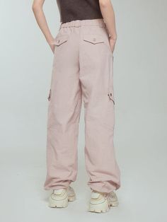 Pink Parachute Pants With Cargo Pockets, Pink Cargo Style Parachute Pants, Casual Pink Full-length Parachute Pants, Sporty Spring Bottoms With Multiple Pockets, Sporty Bottoms With Multiple Pockets For Spring, Pink Relaxed Fit Parachute Pants With Pockets, Pink Bottoms For Spring Outdoor Wear, Pink Elastic Waistband Bottoms For Outdoor, Full Length Parachute Pants With Hip Pockets For Spring