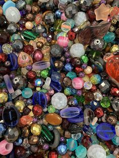 many different colored glass beads are scattered together