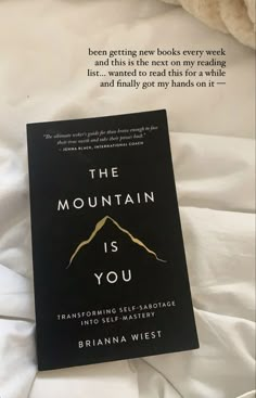 the mountain is you book sitting on top of a bed