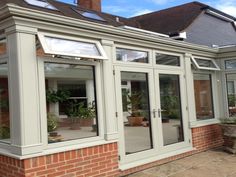 an orange brick building with glass doors and windows